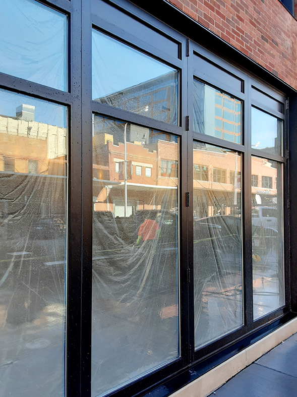 Three four-panel bifold doors with mullions and solid panel insulated aluminum infills (two pictured)