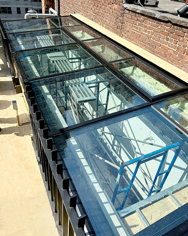 One single slope skylight with an integrated ridge vent and one walkable skylight.