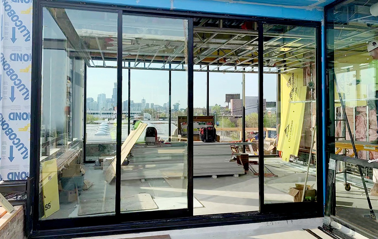 Two multi-track sliding glass door systems