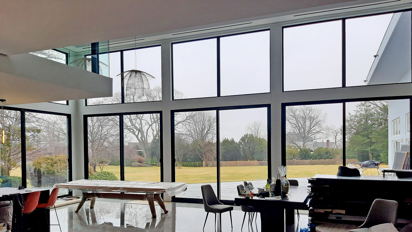 Four two-panel (XX configuration) multi-track sliding glass door units, and four fixed windows.
