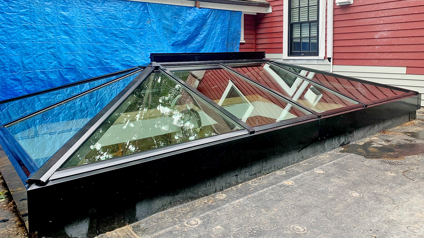 Straight eave double pitch hip end skylight