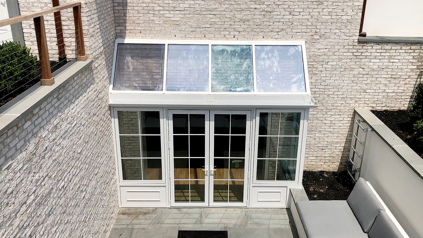 Straight eave lean-to sunroom with integrated French doors and casement windows.