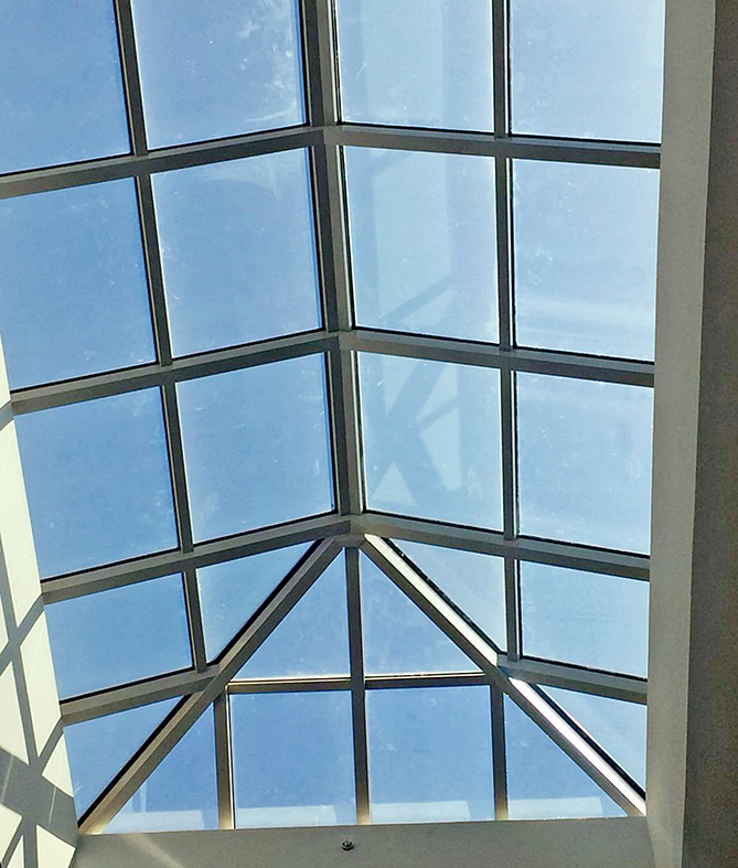 One straight eave double pitch hip end skylight