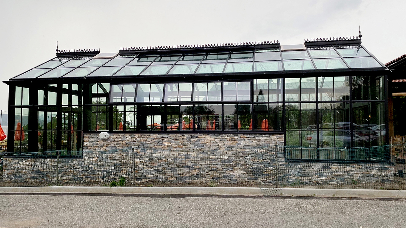 Straight Eave Double Pitch Greenhouse with two four-panel (OXXO configuration) multitrack sliding glass door units, and one seven-panel single door midwall (SDMW) bifold door unit.