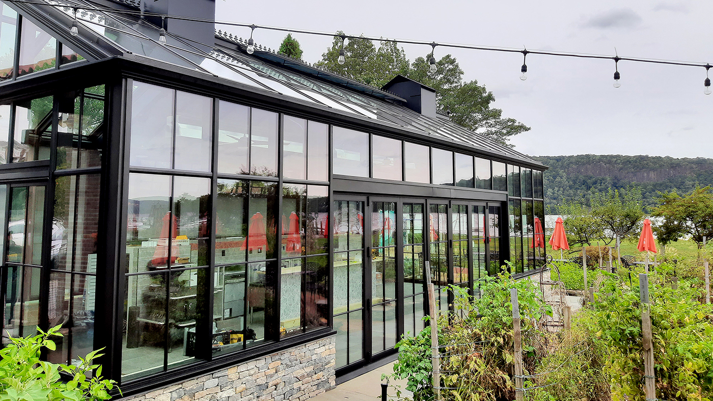 Straight Eave Double Pitch Greenhouse with two four-panel (OXXO configuration) multitrack sliding glass door units, and one seven-panel single door midwall (SDMW) bifold door unit.