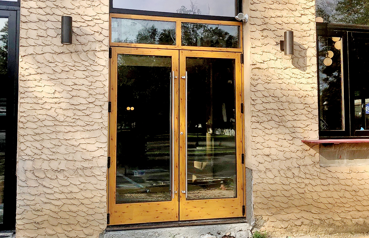 One French Door with a transom finished in Decoral Textured Knotty Pine on both the interior and exterior, one Terrace Door with a sidelite, four Bifold Doors and two Bifold Window units finshed with Decoral Textured Knotty Pine on the interior surfaces only.