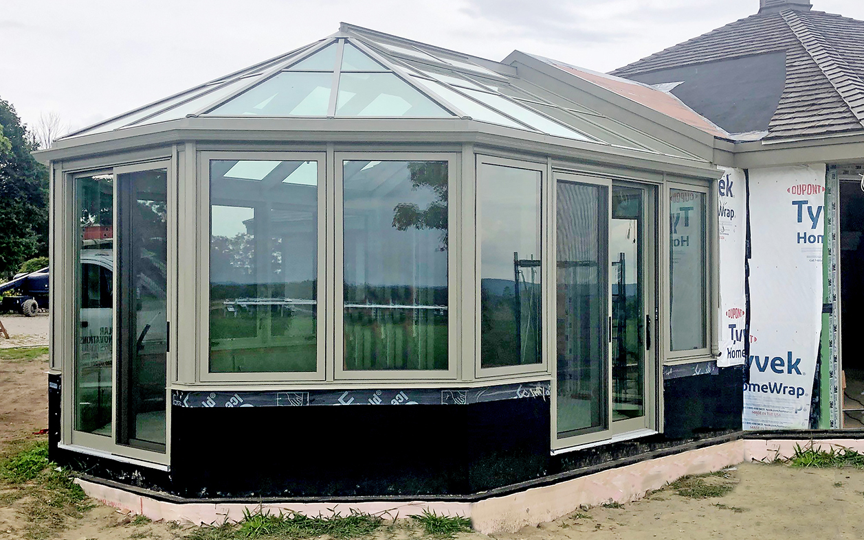 Straight eave double pitch  bullnose end sunroom with integrated sliding glass doors and sliding screens