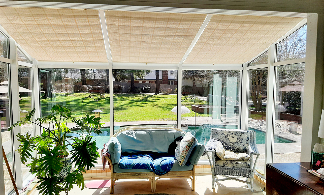 Straight eave lean-to sunroom with a detail photo of an aluminum downspout and pinoleum blinds