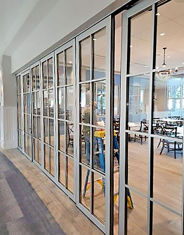 One seven-panel G2 Slide and Stack Wall with an integrated swing door.