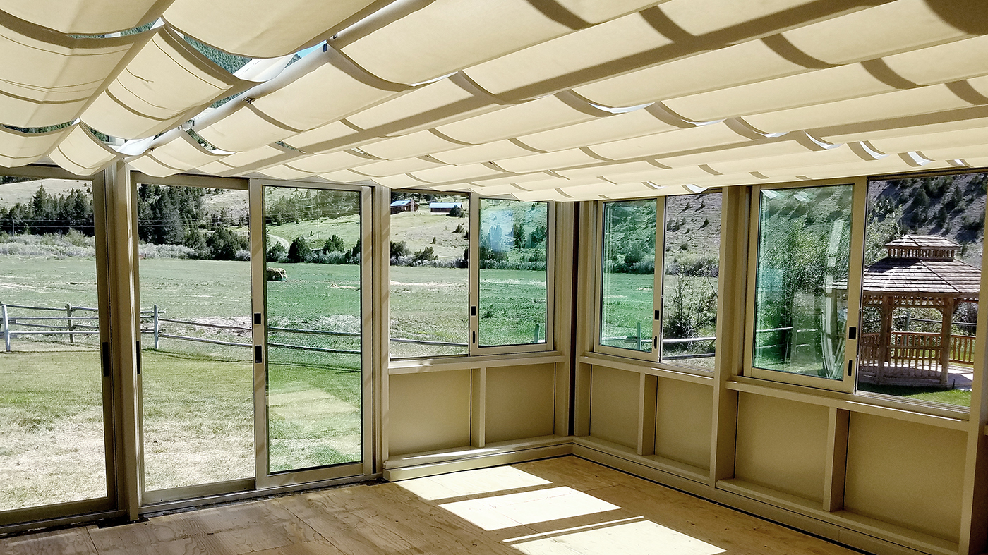 Straight eave double pitch sunroom with bifold door entryway to house