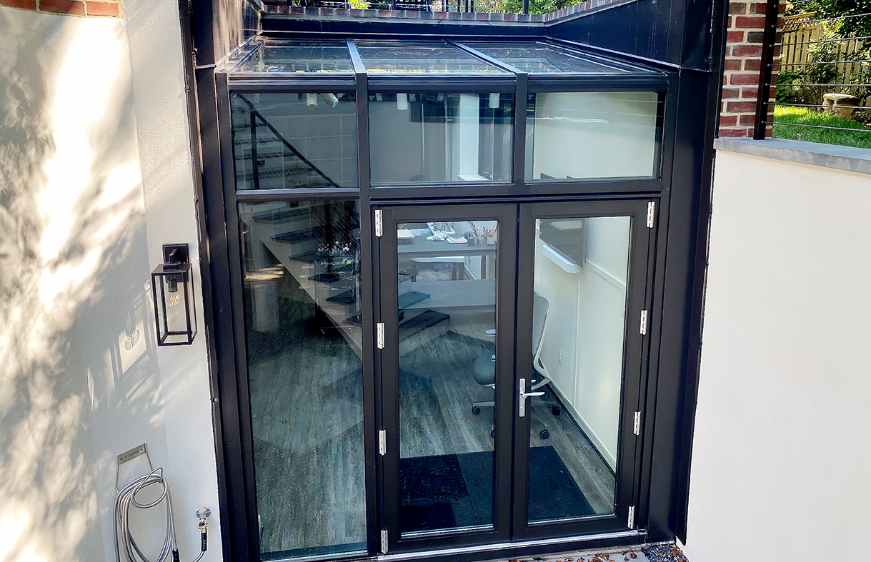 One straight eave lean-to sunroom with an integrated French door unit (photographed), and one straight eave lean-to sunroom with four awning windows.