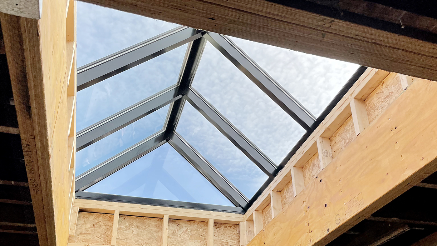 Straight eave double pitch skylight with two gable ends