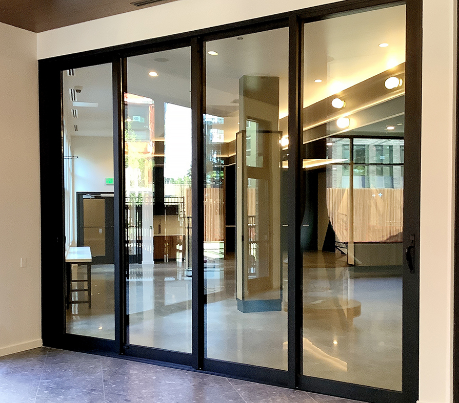One three-panel (XXX configuration) and one four-panel (XXXX configuration) multi-track sliding glass door unit.