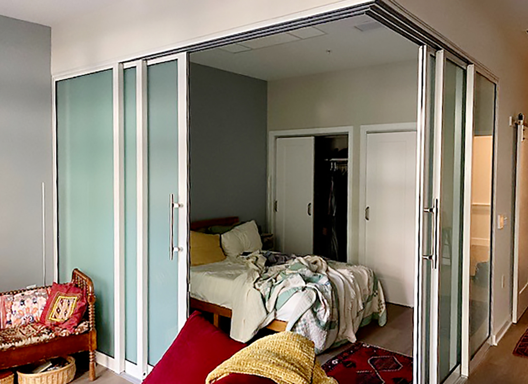 Two six-panel (OXXXXO configuration) G2 no corner post multi-track sliding glass door units with Bandwidth pulls and frosted glass.