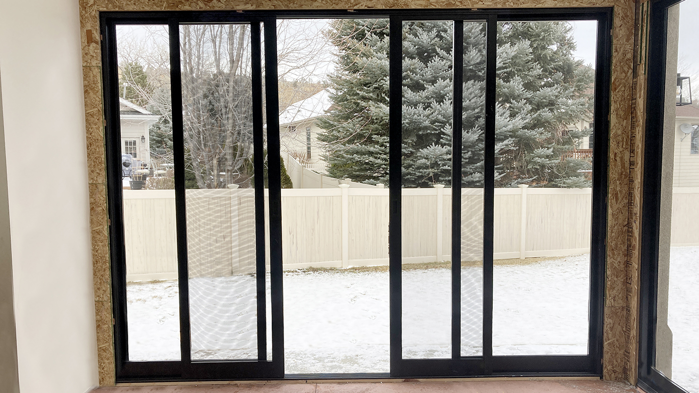 Two four-panel (OXXO configuration) multi-track sliding glass door units