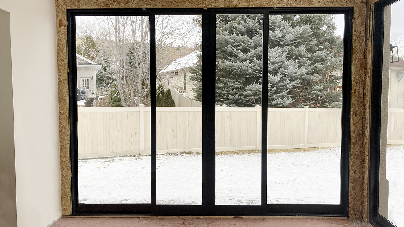 Two four-panel (OXXO configuration) multi-track sliding glass door units
