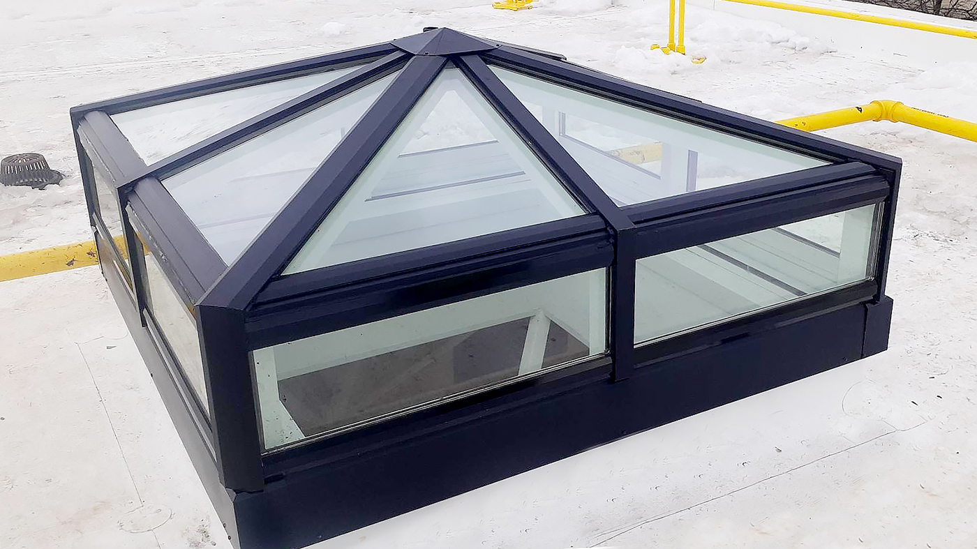 Two pyramid skylights with transoms and two straight eave double pitch hip end skylights with transoms.