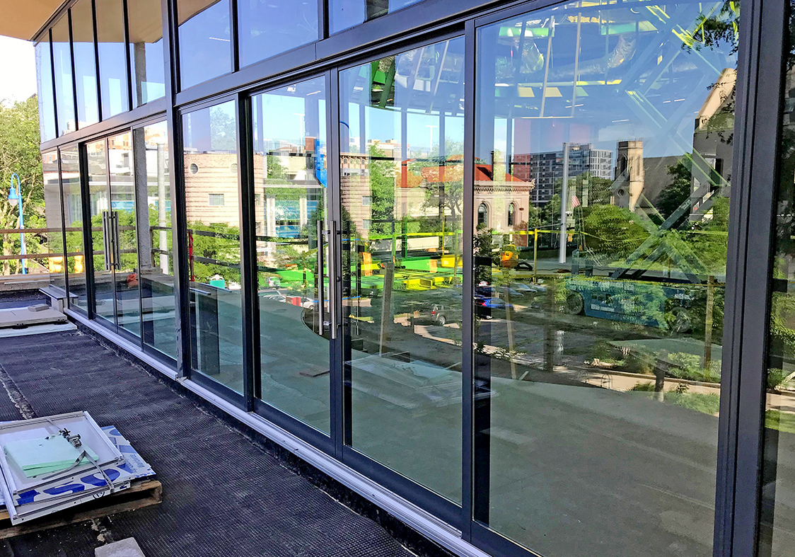 Two four-panel (OXXO configuration) multi-track sliding glass door units.