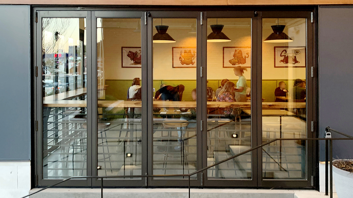 One six-panel and one five-panel outfold split wall bifold door units.