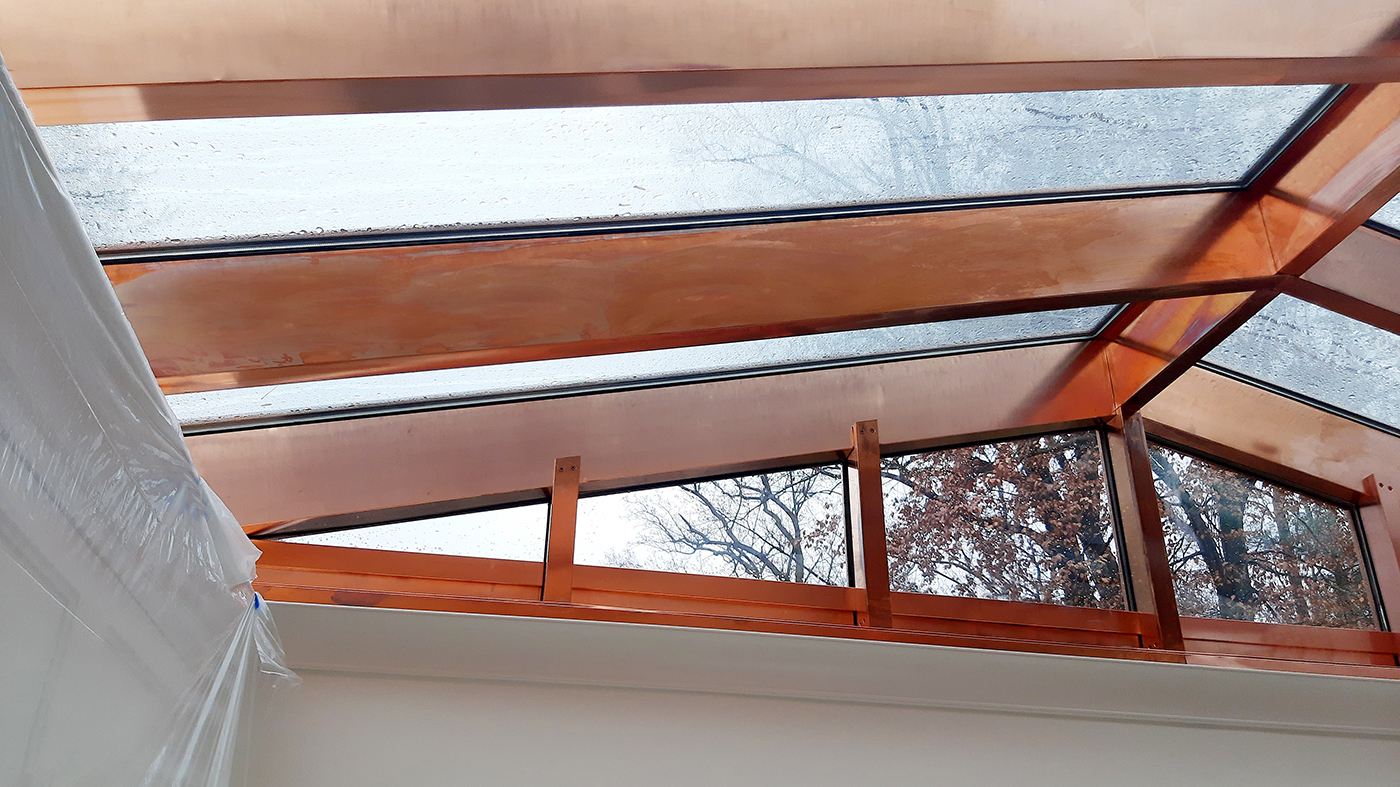 One straight eave double pitch (pictured) and one straight eave lean-to skylight, both clad in copper.