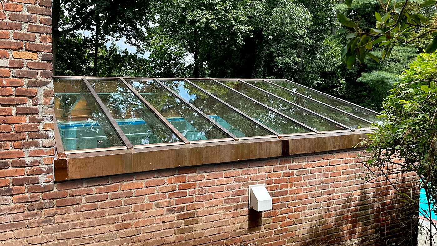 One straight eave double pitch and one straight eave lean-to skylight, both clad in copper.