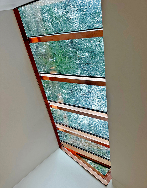 One straight eave double pitch and one straight eave lean-to skylight, both clad in copper.