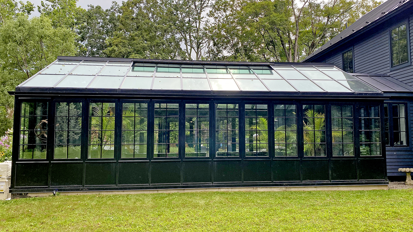 Straight eave double pitch conservatory with an integrated eight-panel G2 outfold split-wall bifold door unit and seven awning windows.