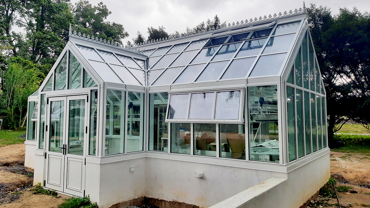 Straight eave double pitch greenhouse with a dormer, French doors, and two faux hubs