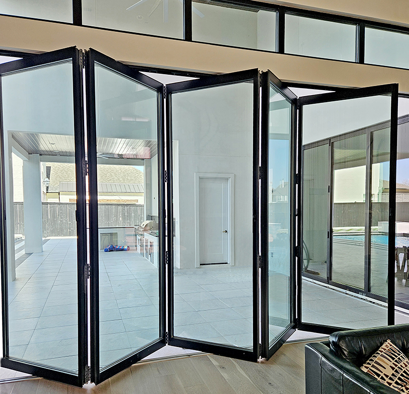 One five panel G3 center pivot all-wall bifold door unit (pictured), one three-panel G3 infold single door last panel (SDLP) bifold door unit, and two aluminum curtain walls.