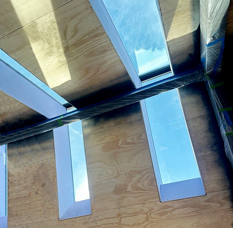 Three straight eave double pitch ridge-mounted skylights.