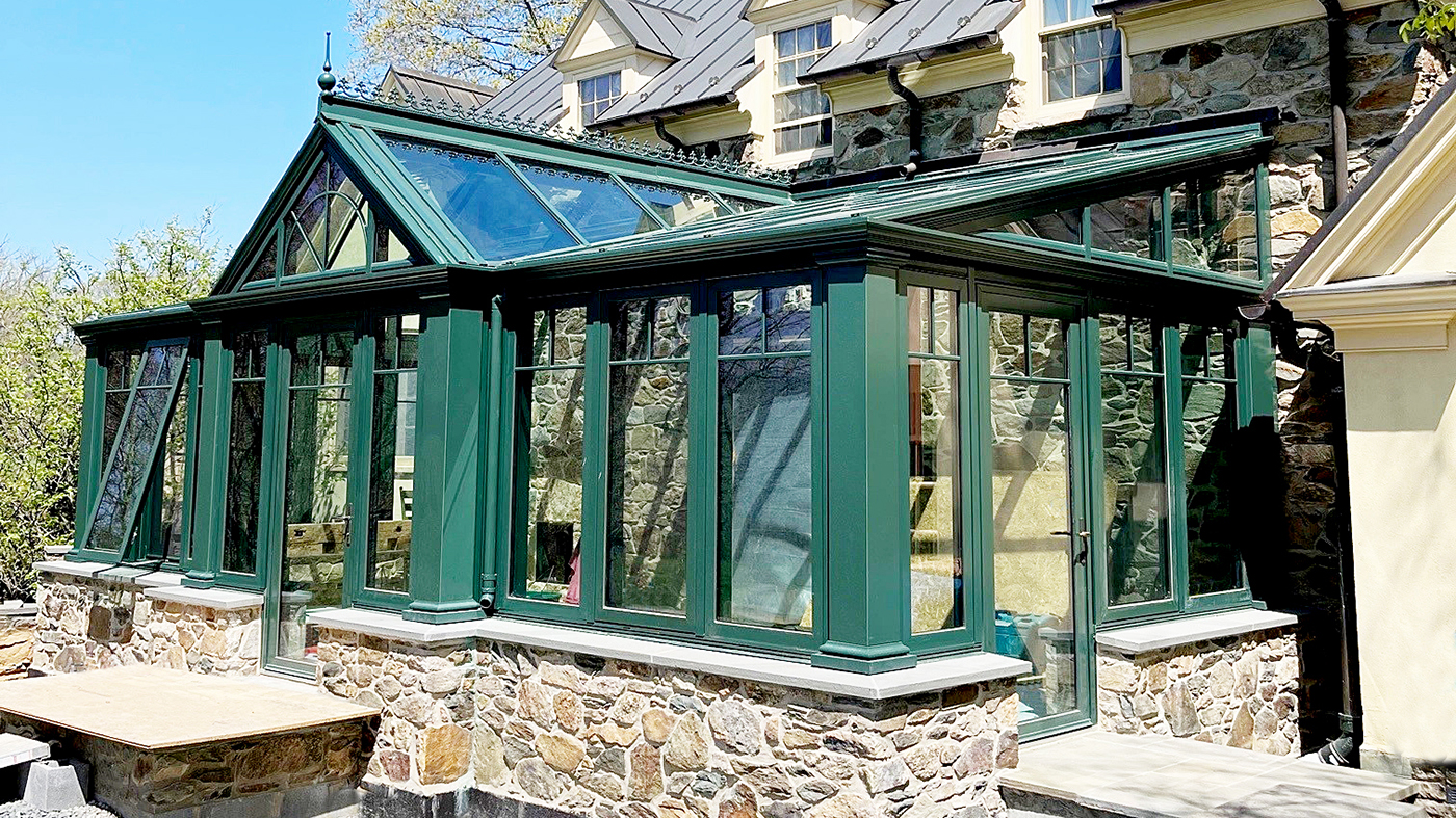 One straight eave lean-to conservatory with a dormer, two integrated inswing terrace doors, and four awning windows