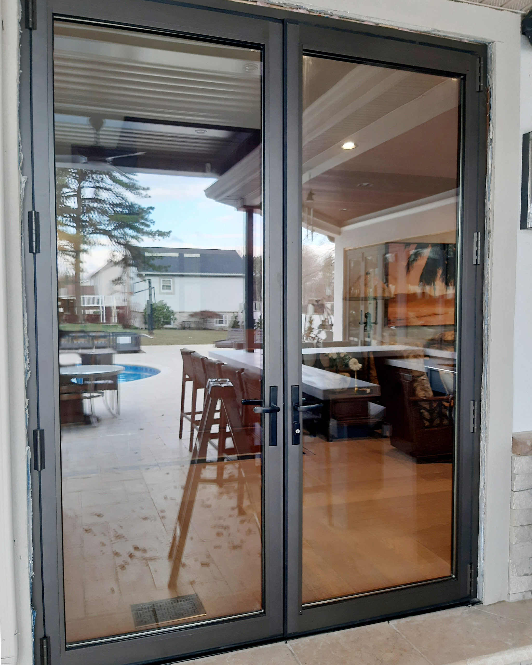 One G2 outswing French door (pictured), one G2 outswing terrace door, one three-panel G2 infold all-wall bifold door unit, and one seven-panel G2 infold split-wall bifold door/window unit.
