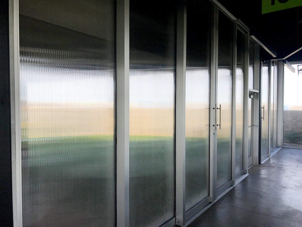 One five-panel (OXXXO configuration) and one three-panel (OXX configuration) G3 multi-track sliding glass door units with a 16mm polycarbonate infill.