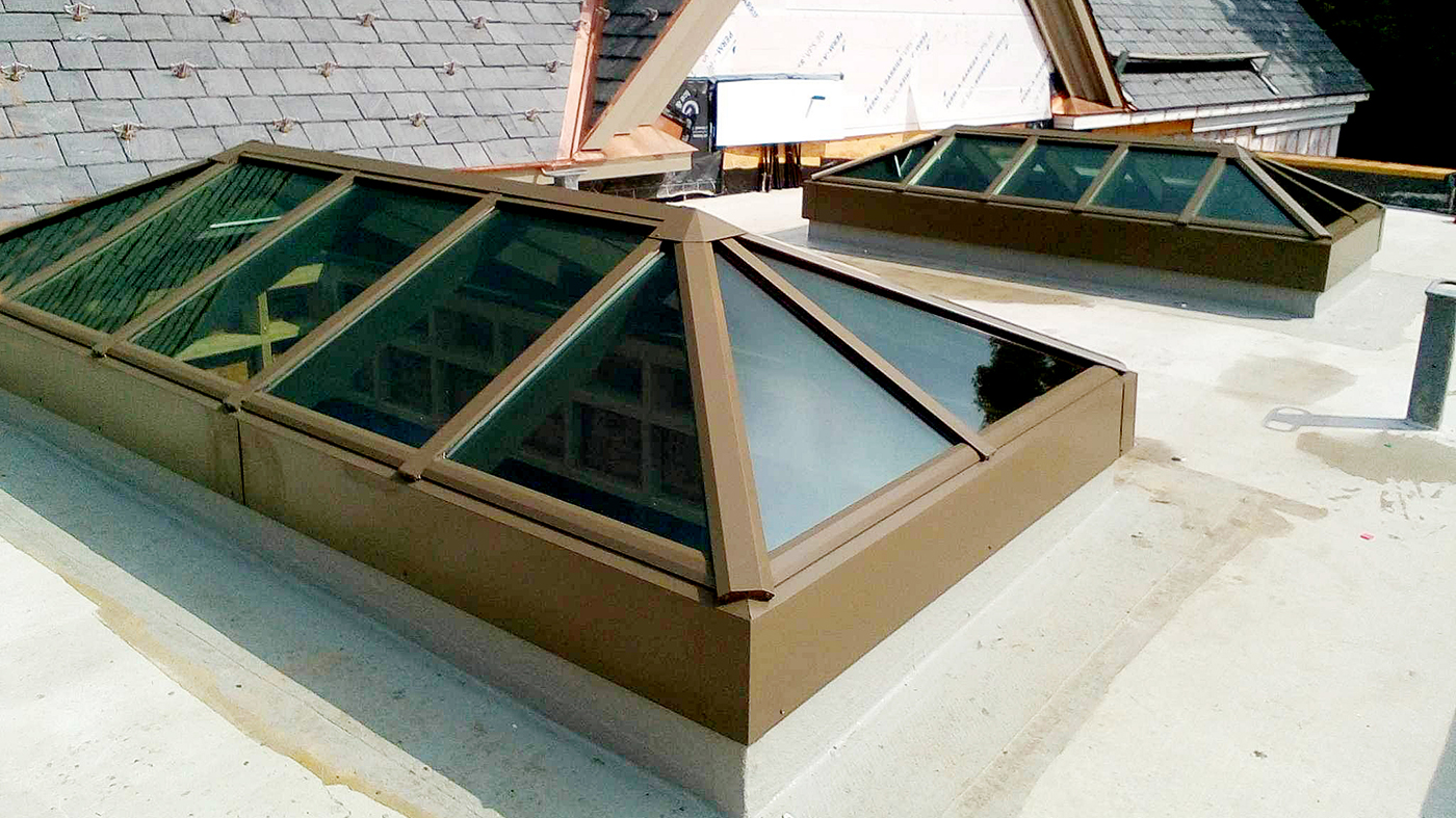 Three straight eave double pitch hip-end skylights