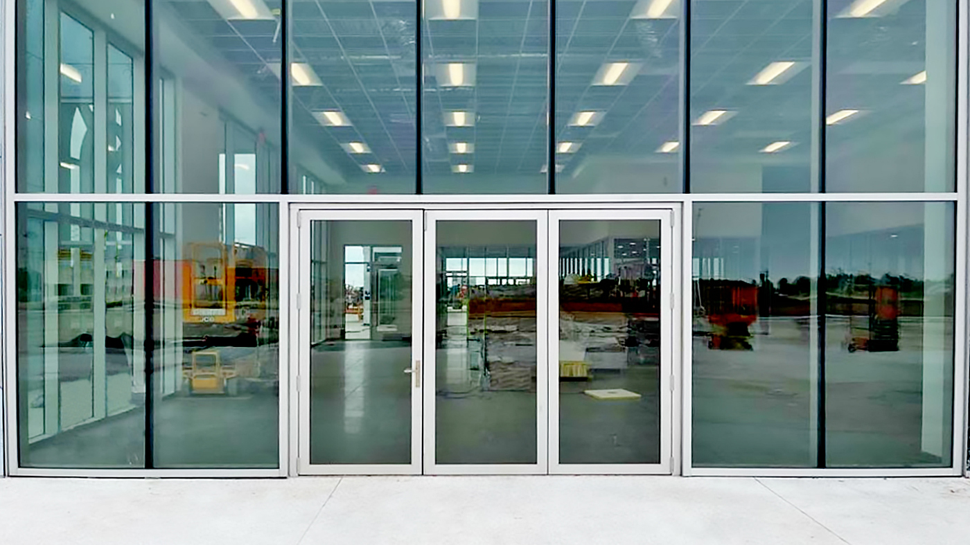 Two three-panel G2 outfold single door hinged jamb (SDHJ) bifold door units integrated into aluminum curtain walls by other.