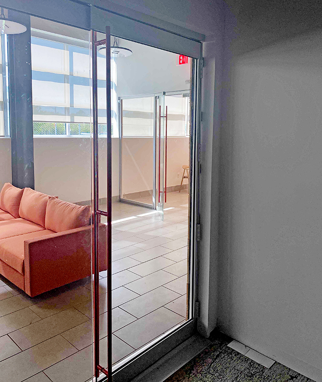 One eight-panel floating offset single door hinged jamb (SDHJ) pivot clear glass bifold door unit with red Bandwidth handles.