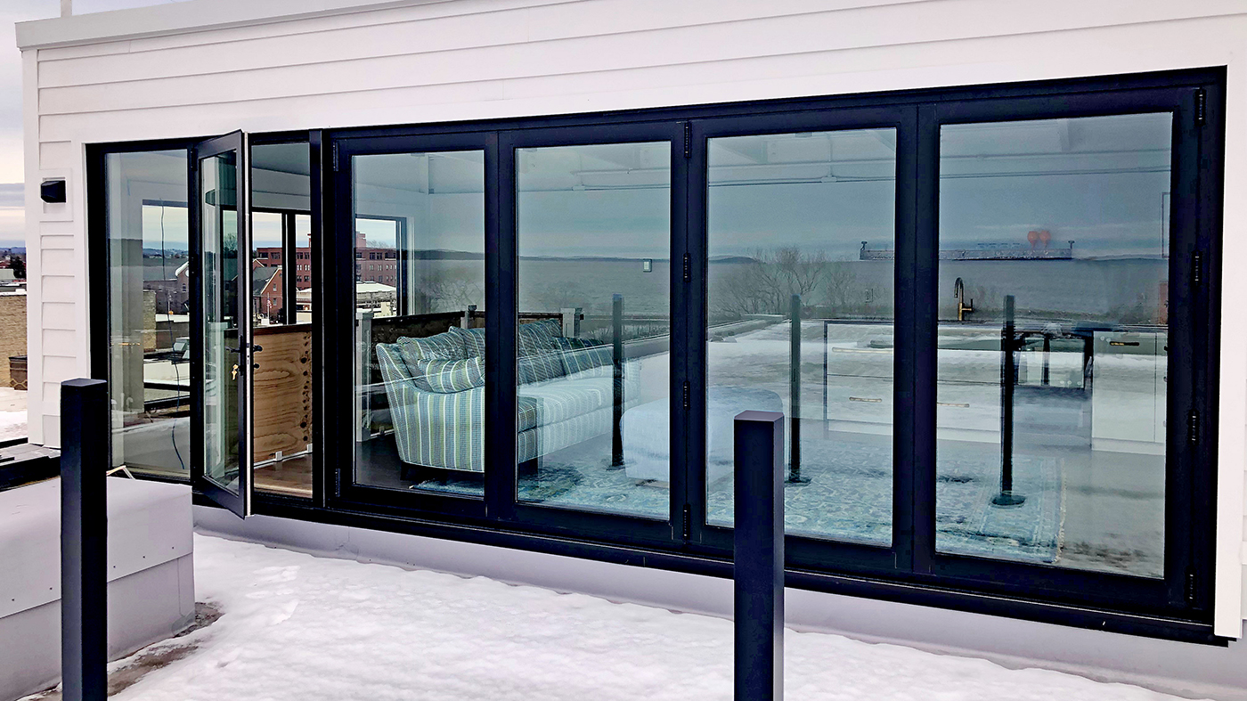One four-panel G2 outfold all-wall bifold door unit with an adjacent G2 outswing terrace door.