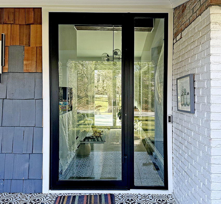 Pivot door with a bandwidth handle and sidelite.