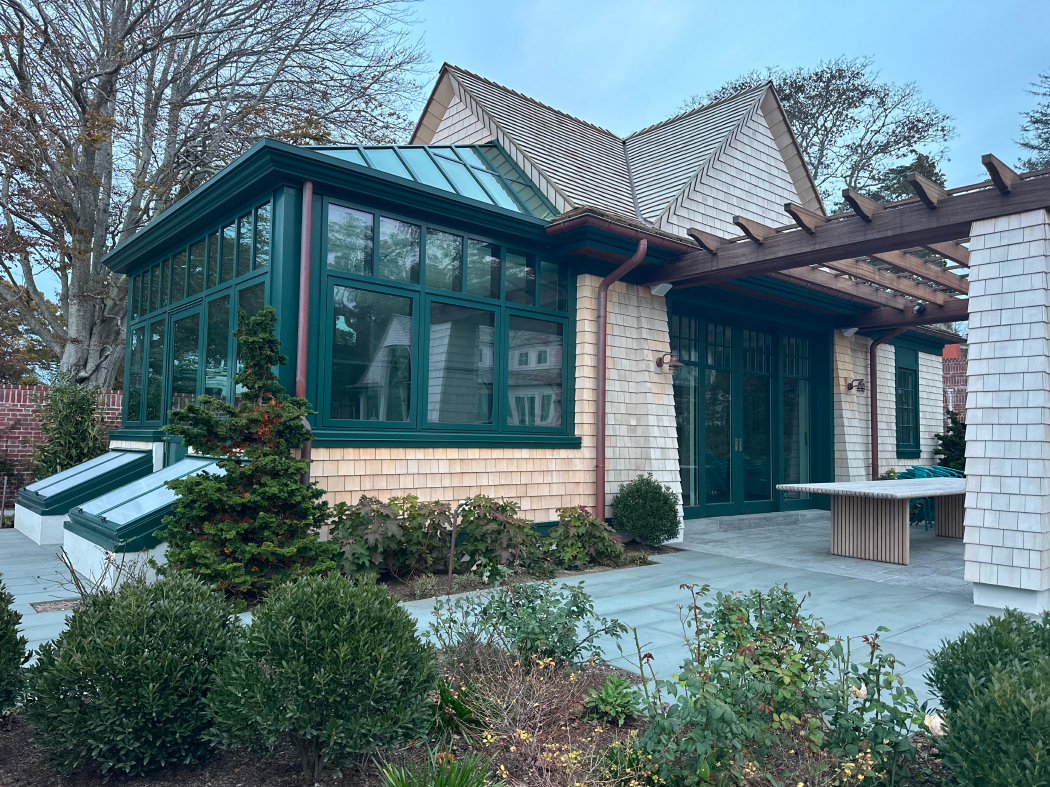 Straight-eave lean-to greenhouse with two hip ends, cold frames, 10 awning windows, and one terrace door.