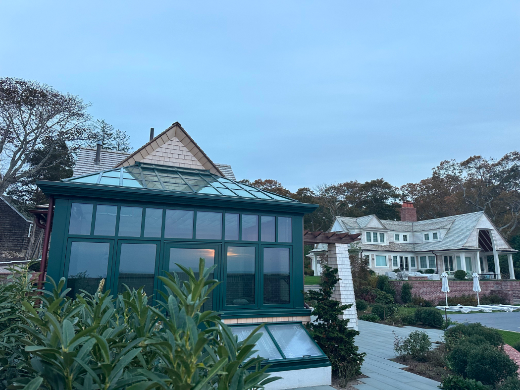 Straight-eave lean-to greenhouse with two hip ends, cold frames, 10 awning windows, and one terrace door.