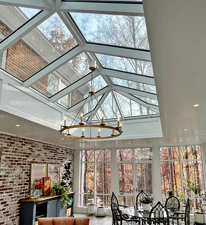 One straight eave double pitch hip end skylight and two aluminum curtain walls, one with integrated casement window.